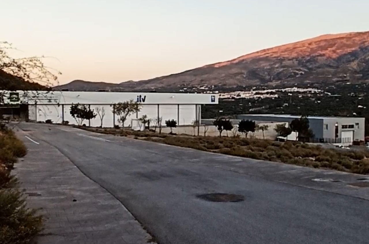 Photo of the ITV building in Tablones with the mountain behind lit by sunrise