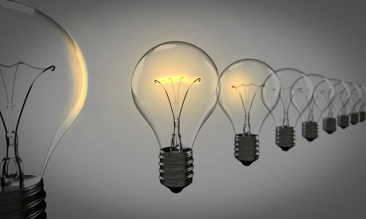 Image showing a row of floating lightbulbs in front of a grey background.